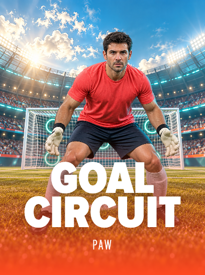 Goalkeeper in a coral jersey, dark shorts and gloves crouched in front of a stadium goal beneath a blue sky.